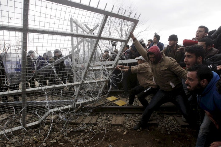 Many walls have been built to block refugees' access to European Union nations from states outside the block, but some are between EU states. Pictured here, refugees and migrants try to bring down a border fence during at the Greek-Macedonian border.