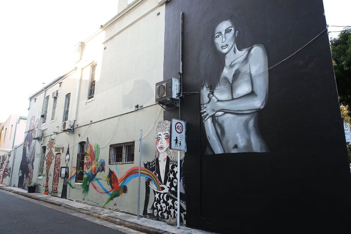 A view of the mural after it was damaged by spray paint and subsequently covered up with black paint. 