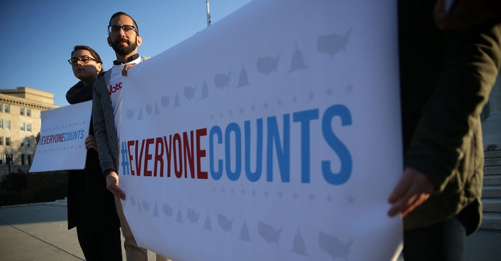 Activists hold signs in front of the Supreme Court on Dec. 8, 2015, before oral arguments on Evenwel v. Abbott. The case considered whether voting districts should be changed to only count citizens who could vote.