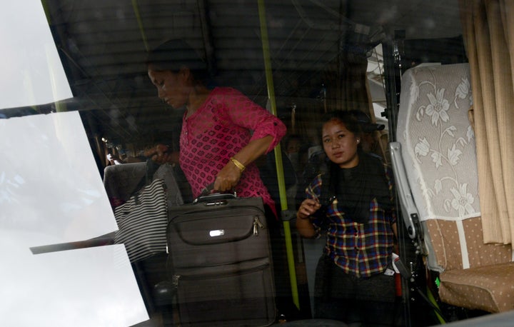 Nepalese women, rescued from a suspected trafficking scheme in India, board a bus on their arrival at Kathmandu's international airport. Thousands of women are trafficked from Nepal every year and campaigners warn that human traffickers can target women and children displaced by a devastating earthquake in Nepal which killed more than 8,800 people.