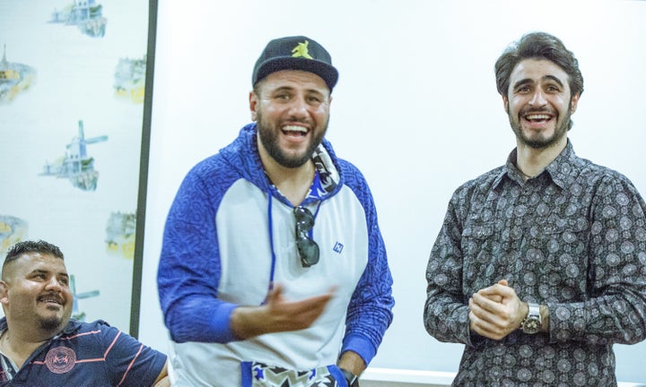 Iraqi creatives laugh during the workshop.