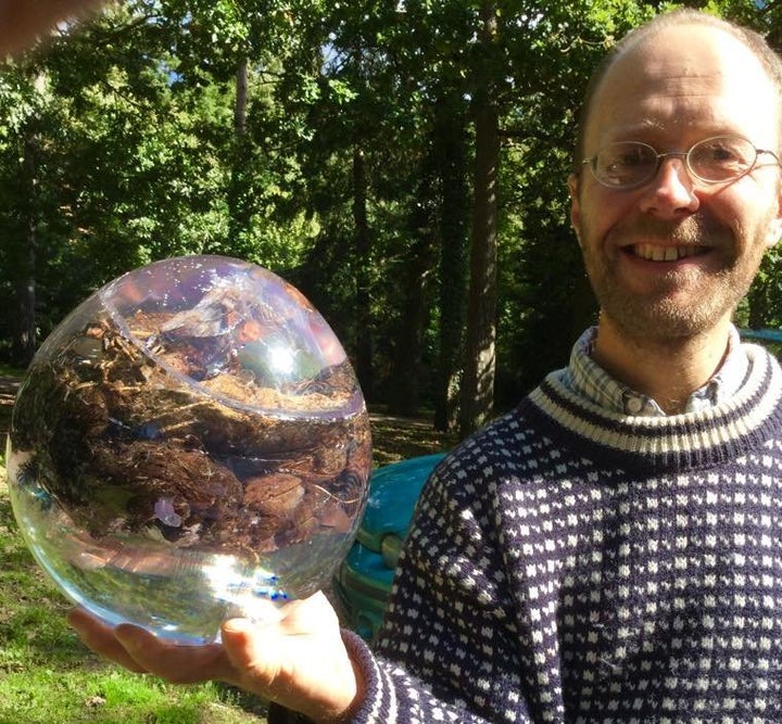 Dan Roberts, a curator for the National Poo Museum, holds a resin-encapsulated horse poo ready for display.