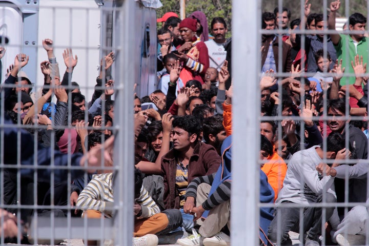 Migrants and refugees protest at a detention center in Lesbos, Greece. Turkey is ready to take another 200 migrants deported from Greece, after it took in a first group on Monday under a controversial EU-Turkey deal.