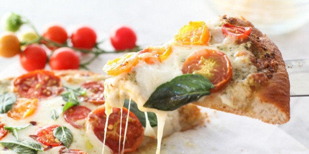 Get the <a href="http://www.foodiecrush.com/2014/08/pesto-pizza-with-fresh-tomatoes-and-mozzarella-and-perfect-pizza-at-home/" target="_blank">Pesto Pizza with Fresh Tomatoes and Mozzarella recipe</a> from Foodie Crush<strong>.</strong>