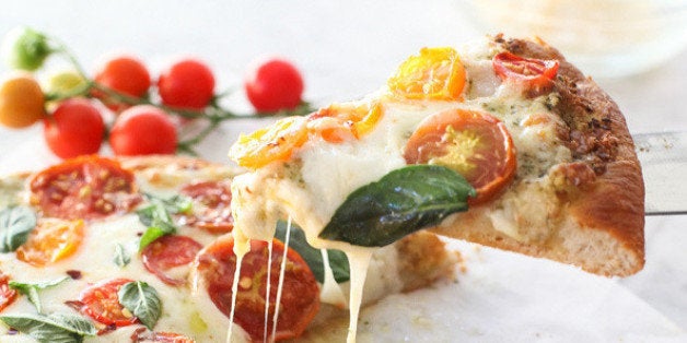 Get the Pesto Pizza with Fresh Tomatoes and Mozzarella recipe from Foodie Crush.