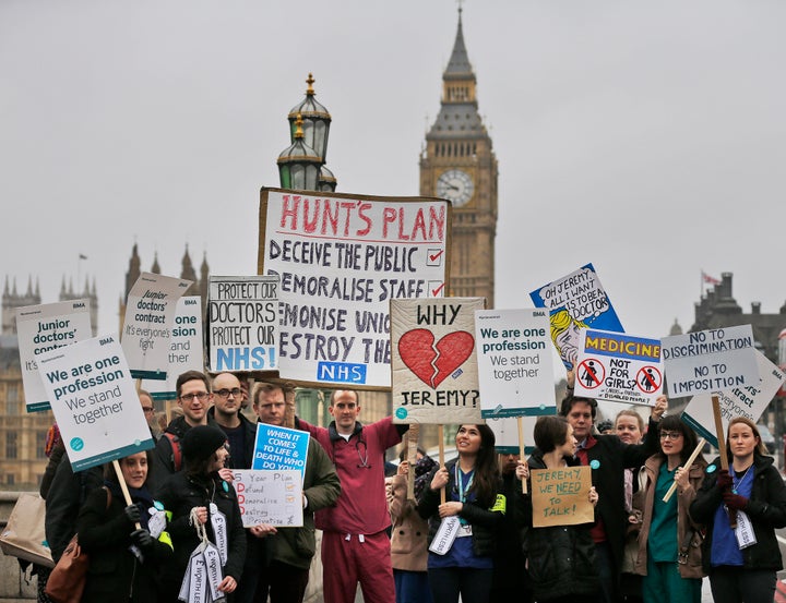 Junior doctors show banners as they start a 48-hour strike at the St Thomas Hospital in London today