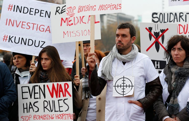 MSF staff demonstrate in Geneva one month after the bombing of the Kunduz hospital. "Even war has rules," one of the banner&n
