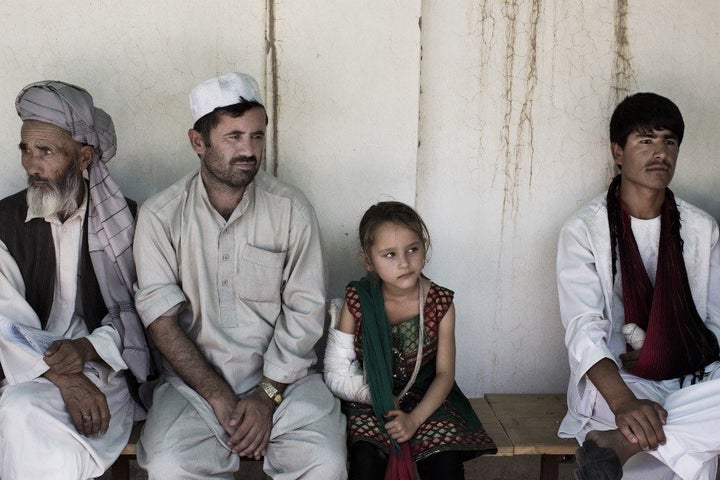 "I feel a sense of hopelessness at this demonstration of transgenerational violence and suffering, resulting from over 30 years of war," Thomas wrote, referring to a patient who had stepped on a landmine. Patients wait for appointments outside the Kunduz trauma center.
