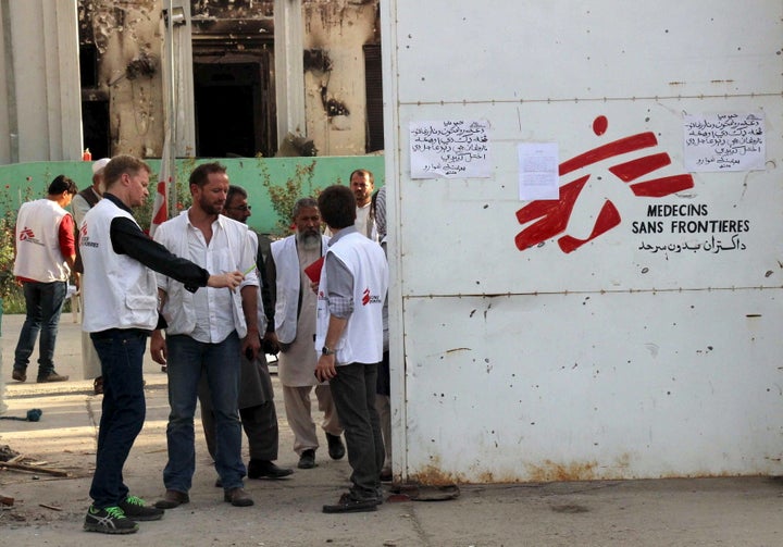 The airstrike attack killed 42 people, including 14 MSF staff members, 24 patients and four caretakers. MSF staff stand outside the entrance of the Kunduz after the event.