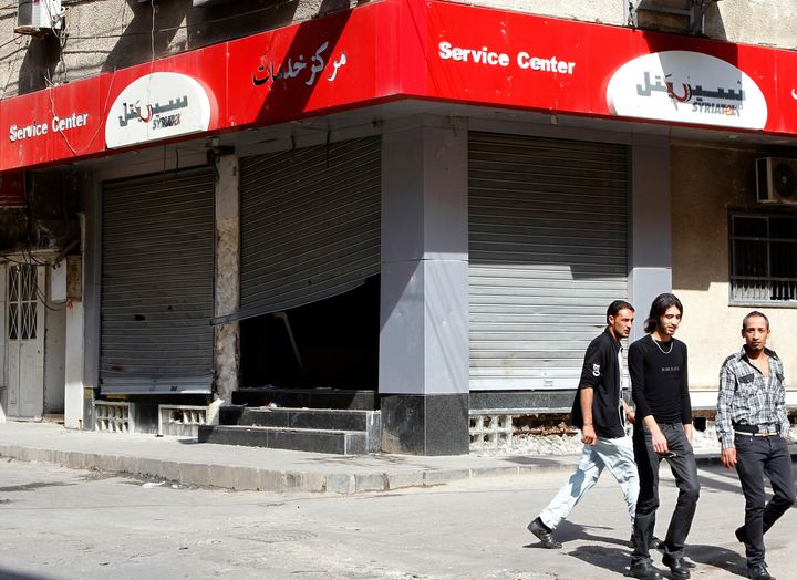 Makhlouf set up Syriatel, Syria's largest cell phone operator, in 2002. An economist who criticized the state for giving him the contract was jailed for seven years. Above, a Syriatel branch is seen after being vandalized during 2011 protests.