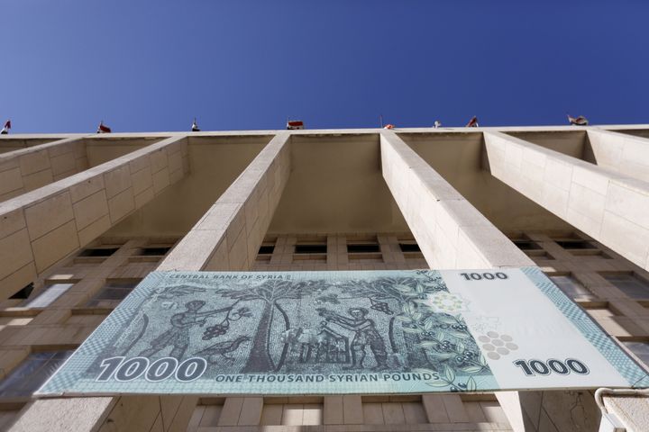 A banner hangs on the Central Bank of Syria in Damascus in March. Syrian state media has not covered the Panama Papers leaks.