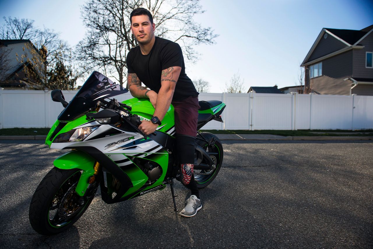 Matias Ferreira and his motorcycle, outside his home in Merrick, New York. 