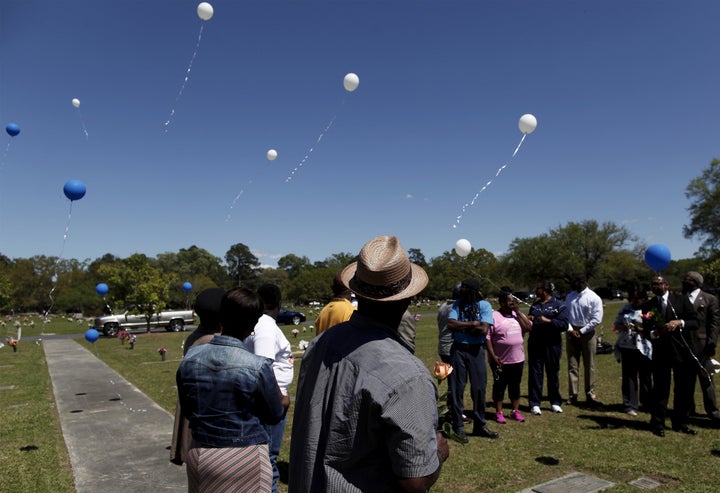 Rodney Scott (C), brother of the late Walter Scott, watches as balloons are released as relatives and friends gathered to rem