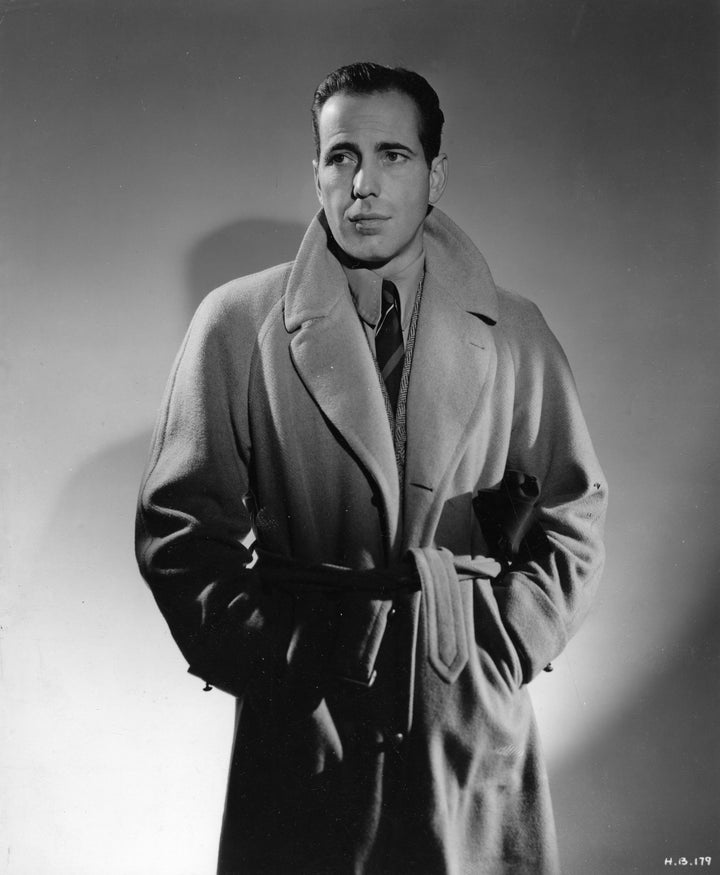 Humphrey Bogart, one of the trench coat's most famous wearers, sports it here in a publicity shot circa 1940.