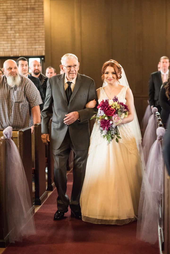 Julia Cain's grandfather walks her down the aisle at her wedding, as her father died in the 1990s.