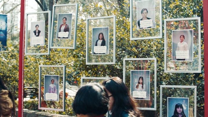 In the video, the women go to a "marriage market" in Shanghai -- but instead of seeking partners, they post messages cel