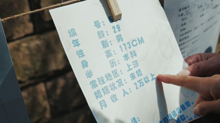 Thousands of parents across China attend marriage markets, where they display signs with information about their children, su