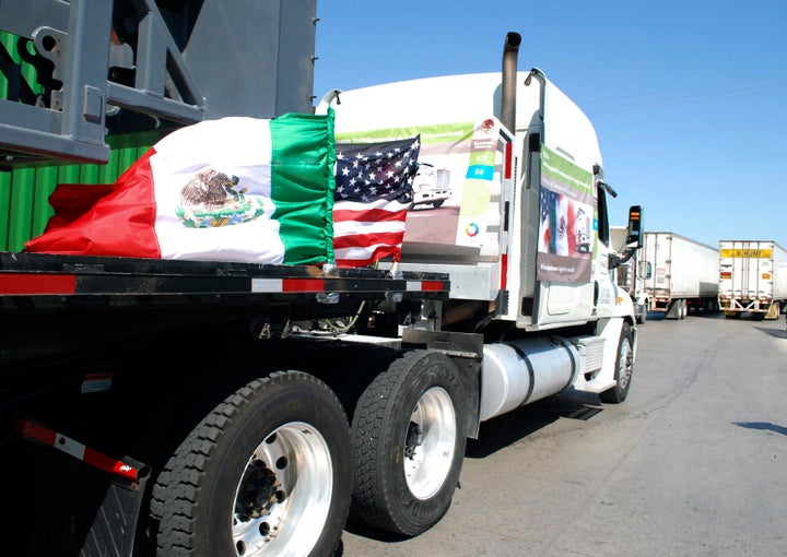 A truck flying Mexican and U.S. flags approaches the border crossing in Laredo, Texas, on Oct. 21, 2011. Trump's proposal to ramp up tariffs on Mexican goods would likely prompt Mexico to retaliate.