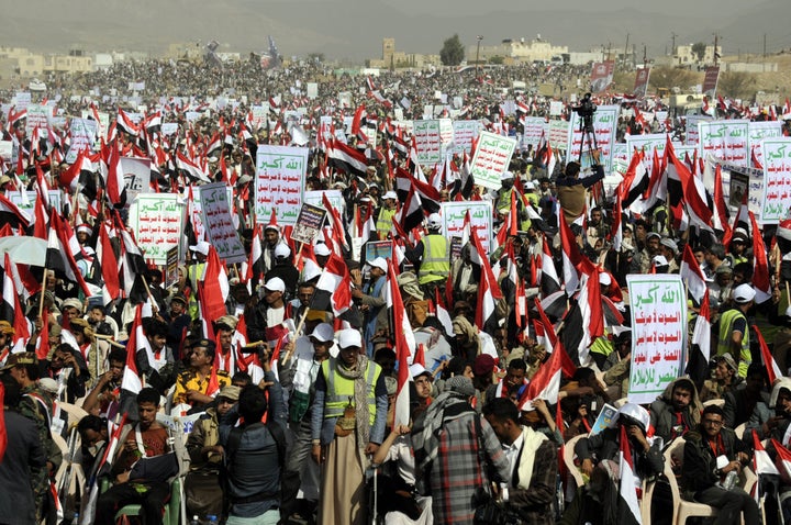 Yemenis protest Saudi-led airstrikes during a rally on the first anniversary of the conflict.