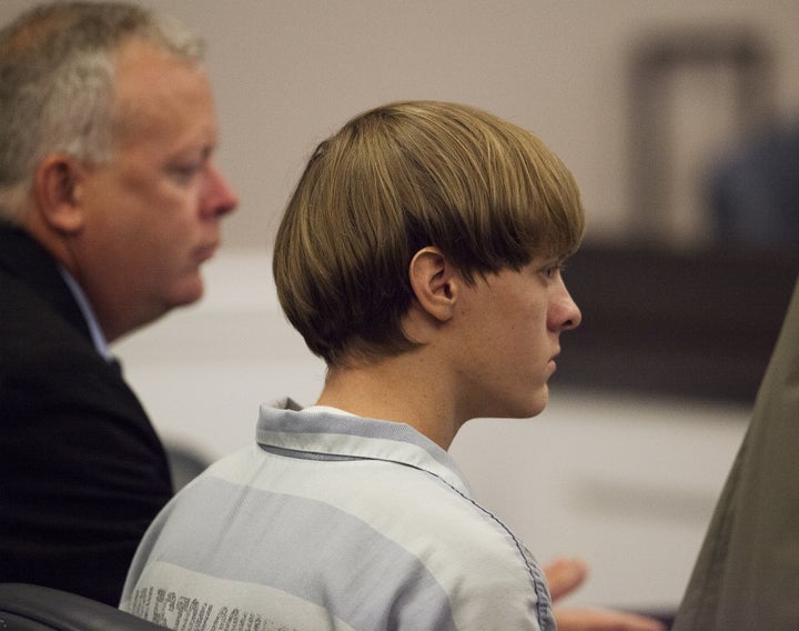 Dylann Roof, the 21-year-old man charged with murdering nine worshippers at a historic black church in Charleston last month, listens to the proceedings with assistant defense attorney William Maguire.