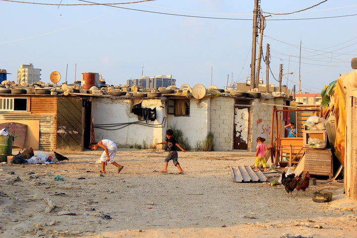 Syrian refugee children play outside a slum complex in Tripoli.