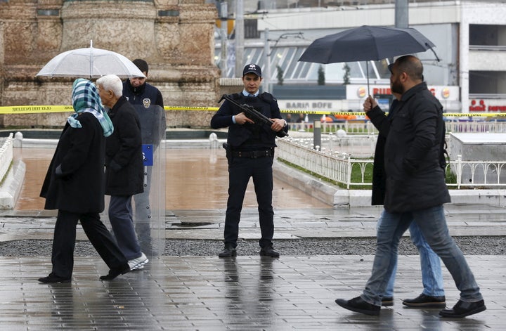 Police officers stand guard at Taksim square after a suicide bombing on a major shopping and tourist district in central Istanbul, Turkey March 19, 2016.