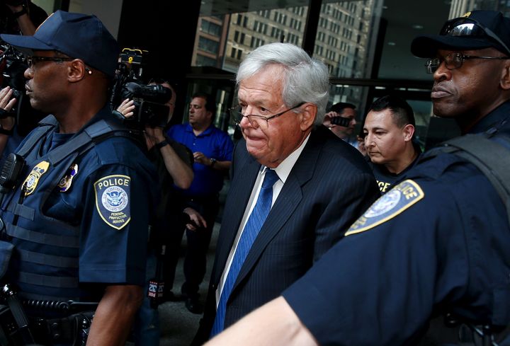 Former U.S. House of Representatives Speaker Dennis Hastert is surrounded by officers as he leaves federal court in Chicago, Illinois, on June 9, 2015.