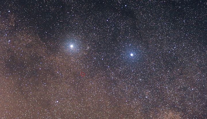 In this photo, the two bright stars are Alpha Centauri (left) and Beta Centauri (right), and the faint red star in the center of the red circle is Proxima Centauri. It could be just a couple of decades before we're able to spend spacecraft to explore them, says entrepreneur Yuri Milner.