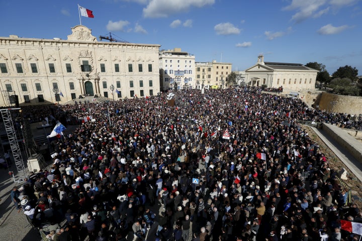 Protesters take part in a demonstration calling on Maltese Prime Minister Joseph Muscat to resign after two members of his go