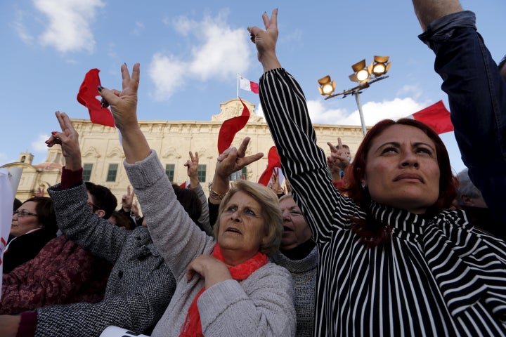 Protestors make victory signs during a demonstration calling on Maltese Prime Minister Joseph Muscat to resign.