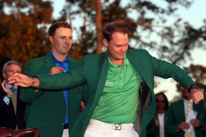 Jordan Spieth of the United States presents Danny Willett with the green jacket.