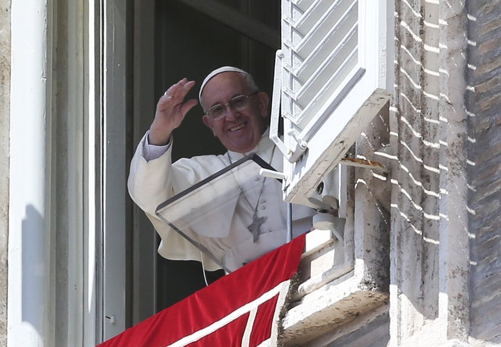 Pope Francis waves as he leads his Sunday Angelus prayer in Saint Peter's square at the Vatican April 10, 2016.