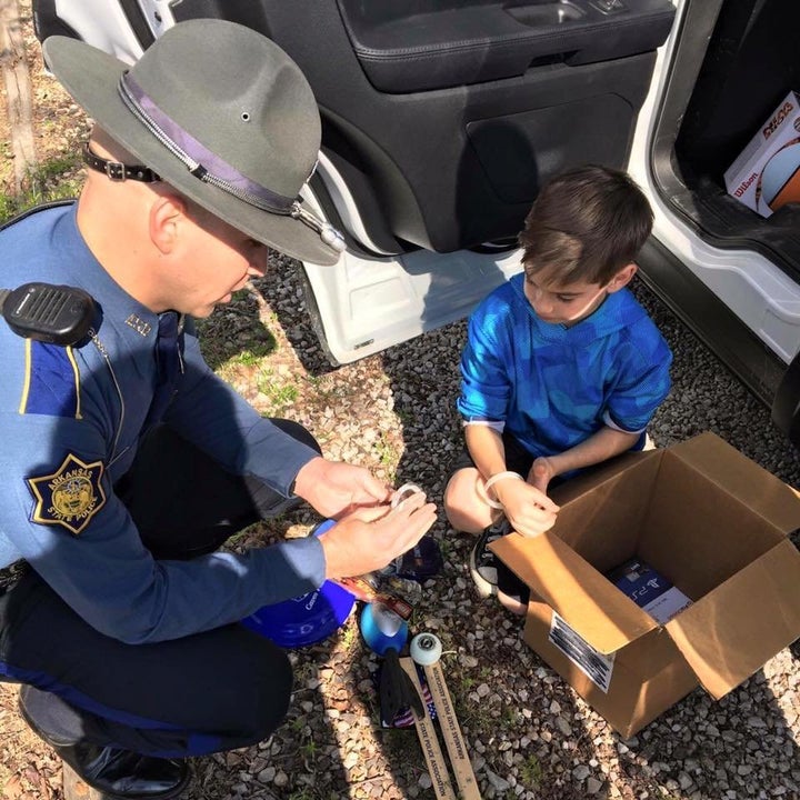 A state trooper talks with Toxey.