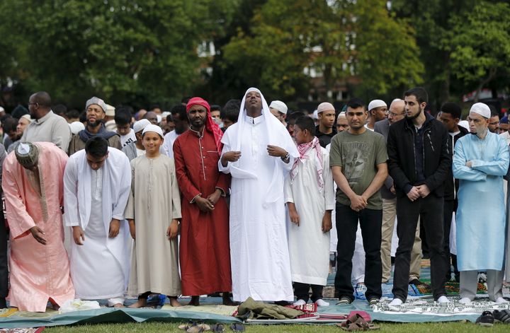 Muslim men prepare before a prayer service for Eid-al Fitr at a park in London in July
