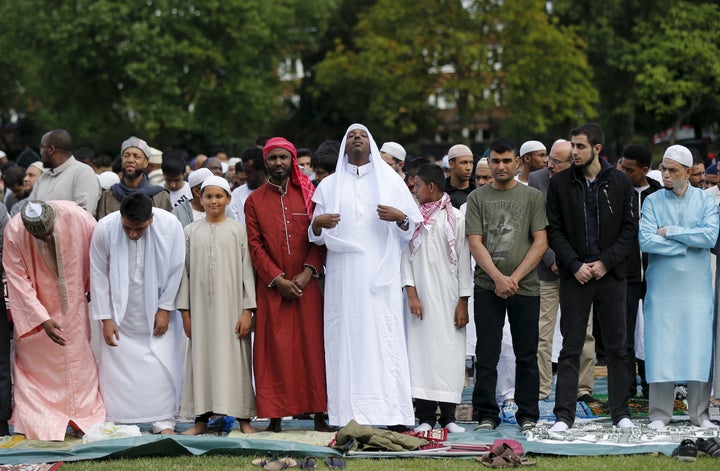 Muslim men prepare before a prayer service for Eid-al Fitr at a park in London in July