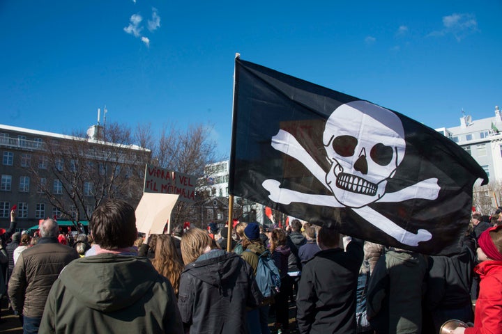 A pirate flag among thousands of Icelanders rallying in Reykjavik on April 9, 2016 to demand immediate elections on a sixth consecutive day of anti-government protests.