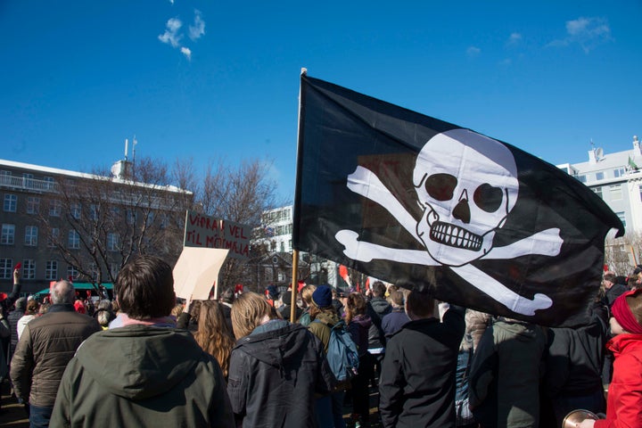 A pirate flag among thousands of Icelanders rallying in Reykjavik on April 9, 2016 to demand immediate elections on a sixth consecutive day of anti-government protests.