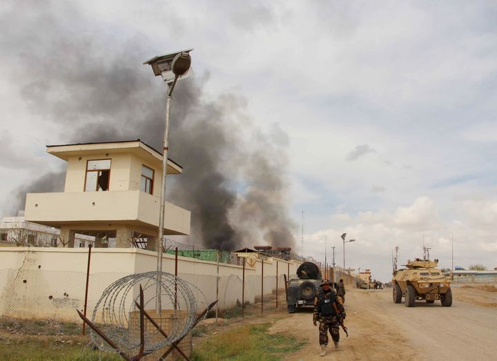 Smoke billows from a building after a Taliban attack in the Gereshk district of Helmand province, Afghanistan.