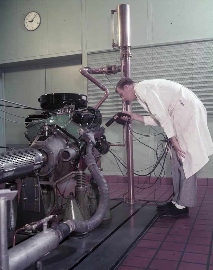 An employee checking engine timing at the Ford Dynamometer Building, 1958.