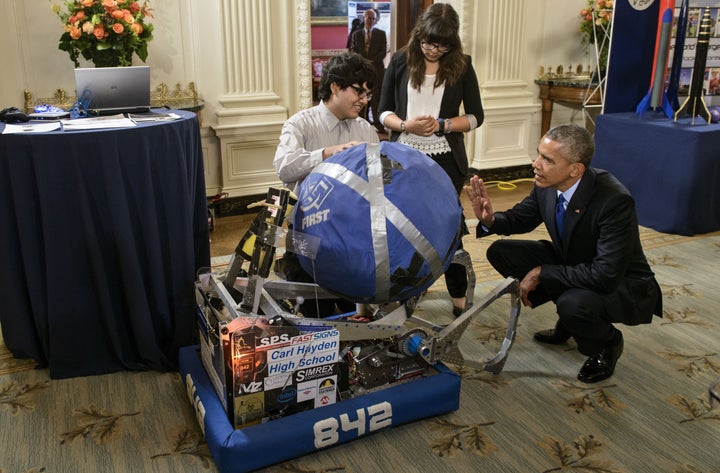 Sergio Corral (left) and Isela Martinez (center), both of Phoenix, Arizona, explained their robot to Obama during the 2015 White House Science Fair.