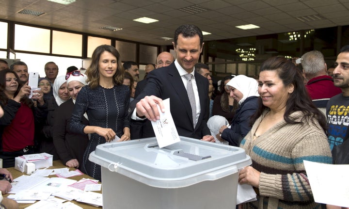 Syrians took part in parliamentary elections in what voters called a show of support for President Bashar al Assad and what opposition groups and countries considered a sham.