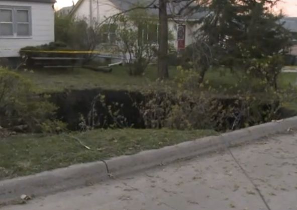 The homeowner heard a sound “like thunder” before he saw a growing hole swallowing his front yard.