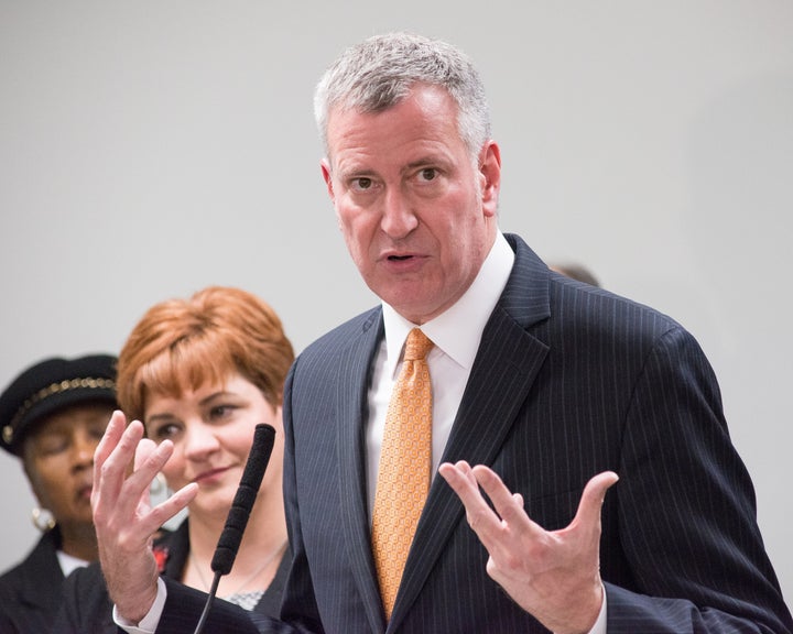 Mayor de Blasio speaks with the press after distributing holiday presents to a group of children living at the residence facility. Mayor Bill de Blasio joined with Human Resources Administration Commissioner Steven Banks and President/CEO of Win -- the 'Women in need' shelter network -- former City Council Speaker Christine Quinn to distribute gifts at a family housing facility in East New York. (Photo by Albin Lohr-Jones/Pacific Press/LightRocket via Getty Images)