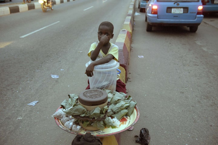 A child sits along the road at night to sell his wares in Nigeria. Many children in the north have little choice, with schools closed or destroyed by six years of fighting between Boko Haram and the military. Experts warn that Nigeria needs to take urgent action to prevent an entire generation of children missing out on education.