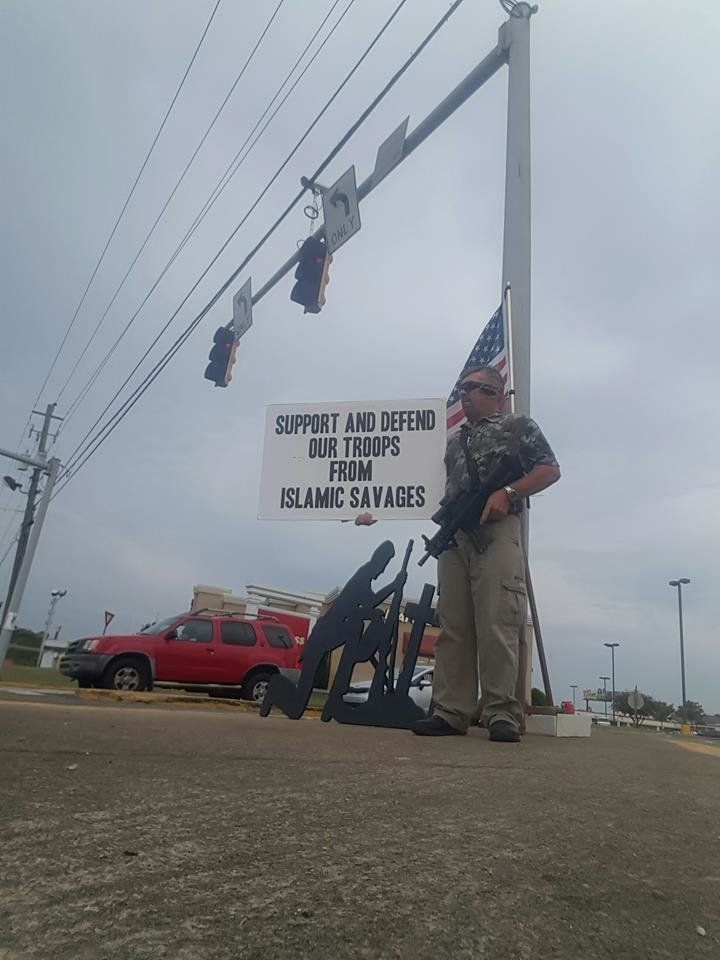 A photo from Stachowiak's Facebook page shows him holding a gun and an anti-Muslim sign. 