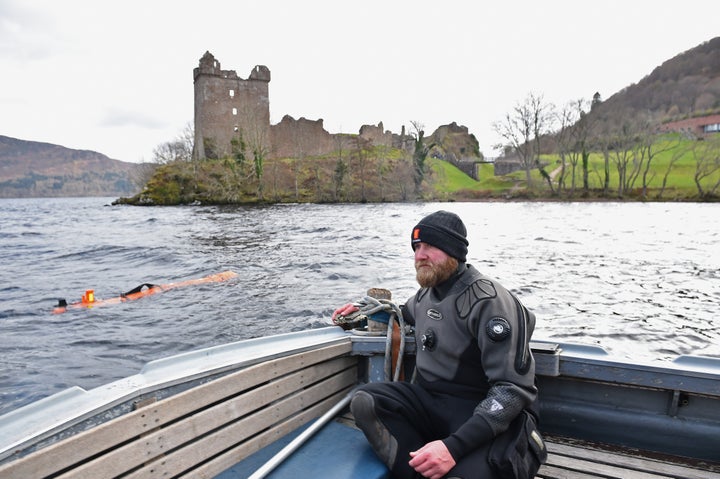 Engineer John Haig monitors the robot as it rests in Loch Ness' water in Drumnadrochit, Scotland, on Wednesday.