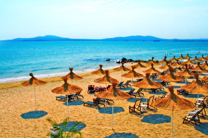 Straw umbrellas on peaceful beach in Bulgaria.