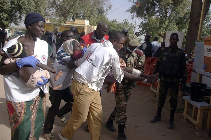 The militant group has increasingly deployed women and children in suicide attacks. Above, wounded women and children are carried by rescuers following suicide attacks in northern Cameroon in January.