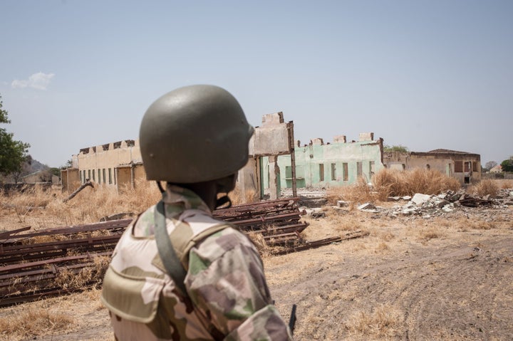 A Nigerian soldier looks at the remains of the Chibok school, where the girls were captured, still in ruins this March. The&n