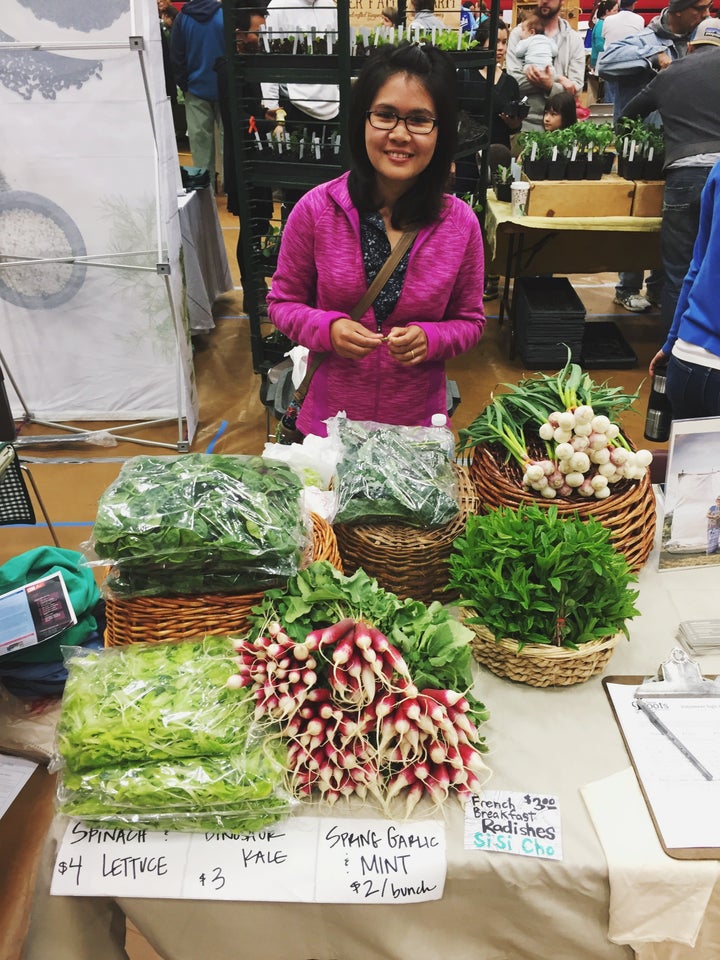 A participant, selling produce at a local farmer's market. 